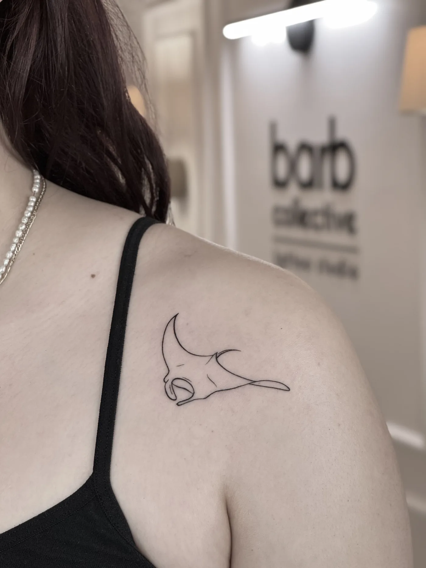 A fine-line manta ray on the shoulder