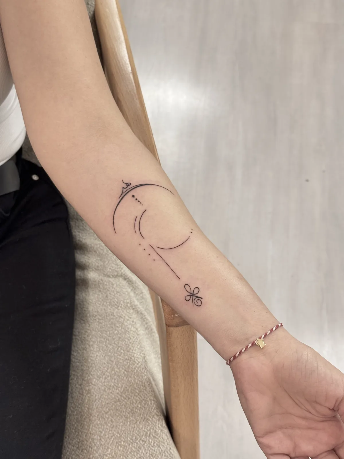 Ornamental — Crescent and charm, forearm
